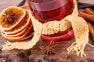 Glass of mulled wine wrapped scarf with fresh fragrant spices