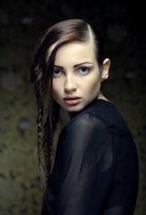 portrait of beautiful young blonde woman with creative braids ha