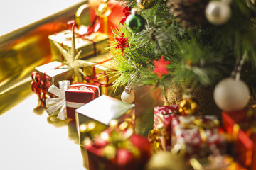Christmas decoration with gifts and present boxes under a pine tree.
Golden harmony, warm atmosphere.
