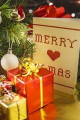 Christmas decoration with gifts and present boxes under a pine tree.
Golden harmony, warm atmosphere.