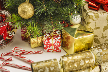 Christmas decoration with gifts and present boxes under a pine tree.
Golden harmony, warm atmosphere.