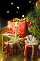 Christmas decoration with gifts and present boxes under a pine tree.
Golden harmony, warm atmosphere.