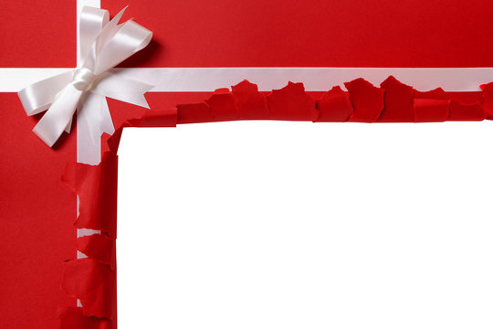 Christmas Gift Torn Open White Ribbon Bow Red Wrapping Paper Background Opening Unwrapping Present Photo