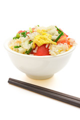 homemade fried rice with tomatoes and egg with chop sticks on white with clipping path vertical