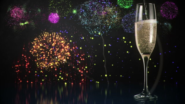 Glass of champagne with fireworks on background