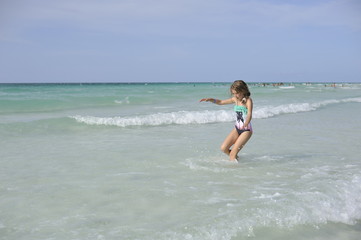 Fototapeta premium Happy girl have fun in the blue sea.