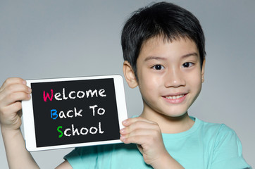 Little asian boy smiles with tablet computer  With Back to Schoo