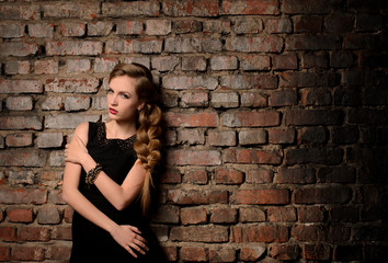 young woman on brick wall background