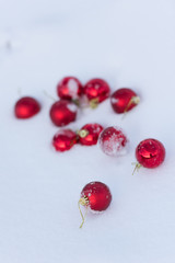 red christmas balls in fresh snow