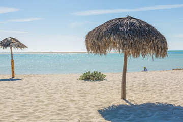 Fototapeta na wymiar Beach Umbrella made of palm leafs on exotic beach