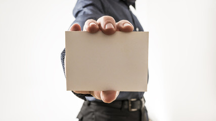 Closeup of a man showing a blank white business card