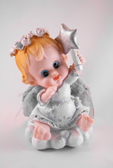 Funny little angel figurine with Christmas star in his hand (it is not the author's work, souvenir, consumer goods)
