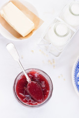 .Jam with red grape in a glass jar on a white background. Top view.