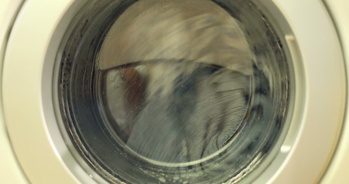 Clip of a high efficiency washing machine (side loader) washing laundry.