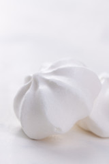 Closeup of meringue cookies on a white background, selective focus.