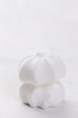 Closeup of meringue cookies on a white background, selective focus.