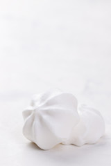 Fototapeta na wymiar Closeup of meringue cookies on a white background, selective focus.