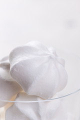 Closeup of meringue cookies on a white background, selective focus