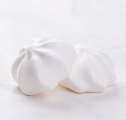 Fototapeta na wymiar Closeup of meringue cookies on a white background, selective focus