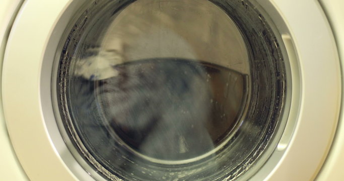 Clip of a high efficiency washing machine (side loader) washing laundry.