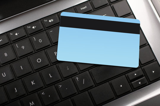 Bank card on laptop keyboard closeup