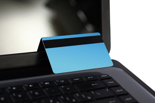 Bank card on the laptop on a white background closeup