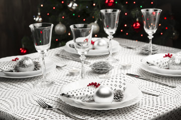 Christmas dinner table. Traditional Christmas decorations. Served table in a restaurant. Beautifully set table for Christmas Eve.