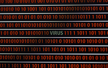 A virus message in the screen. The virus word is in green and zeros and ones are in red. Image...
