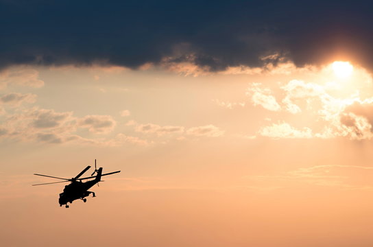 silhouette of the helicopter on the sunrise background