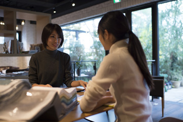 Women are choosing a sample of the fabric