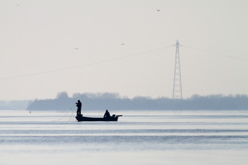 Two fishermen fishing by fishnet