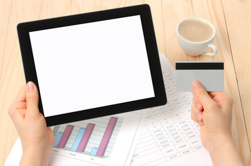 Businesswoman works at her workplace with Tablet PC and credit card.
