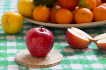Fresh gala apple on a table with fruit basket in background