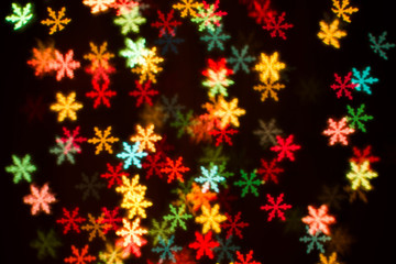 Blurring lights bokeh background of colorful snowflakes