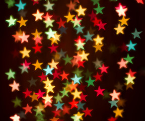 Blurring lights bokeh background of colorful stars