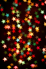Blurring lights bokeh background of colorful stars