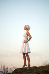 Fototapeta na wymiar Woman in white dress outdoor