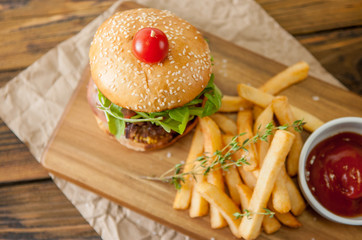 Home made burgers on wooden background