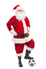 Santa Claus stepping over a football