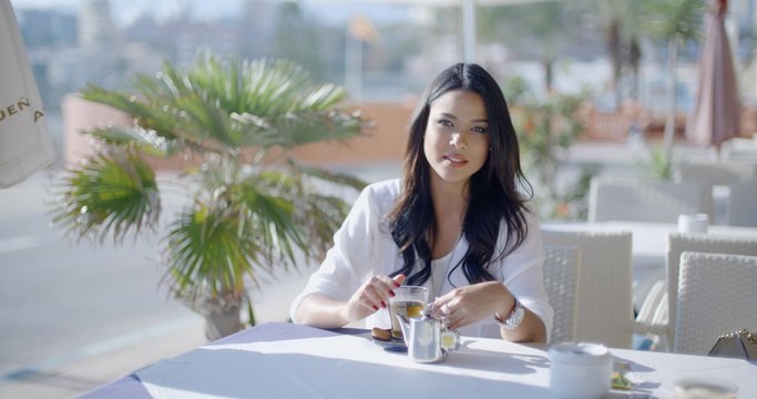Girl Sitting At Cafe With Cup Of Tea