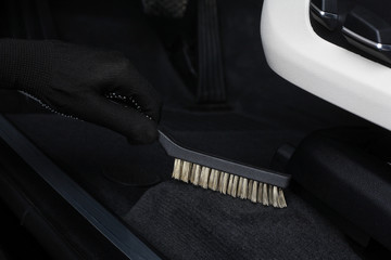 Car service. Cleaning of  interior by a scrubbing brush