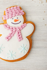 Gingerbread snowman on the white table  vertical