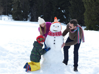 happy family making snowman