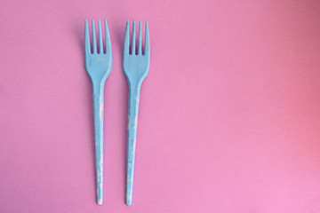 Blue fork on pink background - party time concept