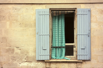 Opened wooden window with blue shutters