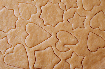 Fototapeta na wymiar Dough rolled out and cookies cut out