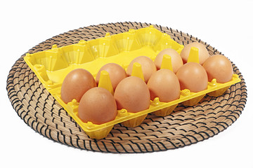 Chicken's eggs in box  yellow color on white background and wick
