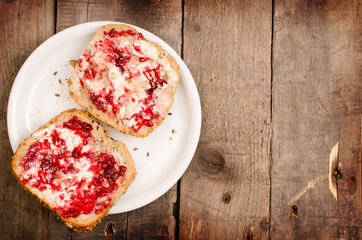 Raspberry jam on whole grain rolls