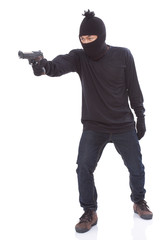 Fototapeta na wymiar Burglar holding hand gun 