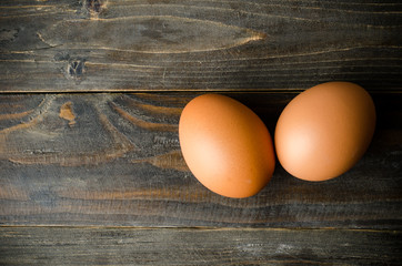 Fresh eggs on wooden background (food ingredient)